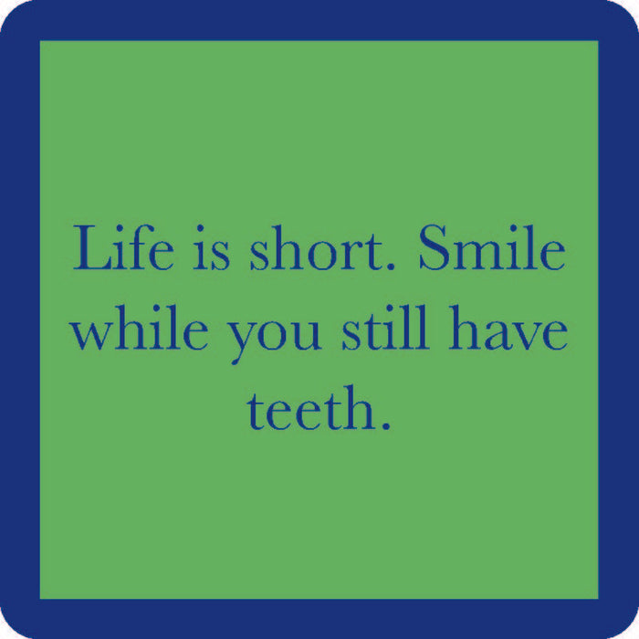 The Smile While You Still Have Teeth Coaster by Drinks On Me features a green square with a blue border and bold blue text—an amusing addition to your bar cart or the perfect funny drink coaster for your home.