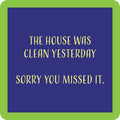 The Sorry You Missed It Coaster by Drinks On Me is a blue square with a green border and yellow text: "The house was clean yesterday. Sorry you missed it." A funny coaster, perfect for housewarming gifts or bar cart accessories.