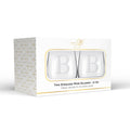 A boxed set of two Maple Stemless Wine Glasses (21 oz), each laser-engraved with a large letter B. The white packaging features gold geometric accents and the Maple logo.