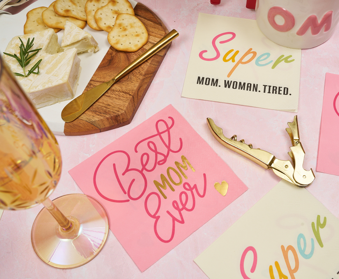 Sugarplum Best Mom Ever Cocktail Napkins (26pk) feature pink and gold lettering—ideal for Mother’s Day parties as party supplies or cocktail napkins. Perfect pairing with cheese, crackers, wine glasses, and Super Mom cards.