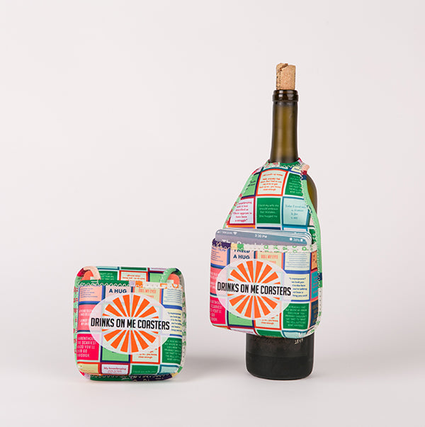 A vibrant HOOK-r wine bottle tag with a matching coaster, both featuring witty text and sunburst design from Drinks On Me, shown on a plain white background.