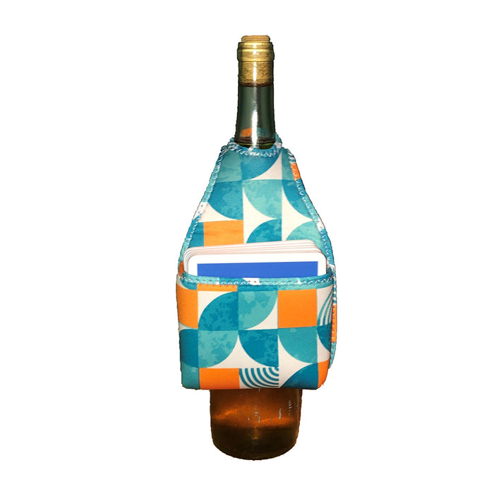 The HOOK-r by Drinks On Me: A wine bottle wrapped in a colorful geometric fabric holder (blue, orange, white) with a front pocket carrying two small notebooks. Set against a plain white background.