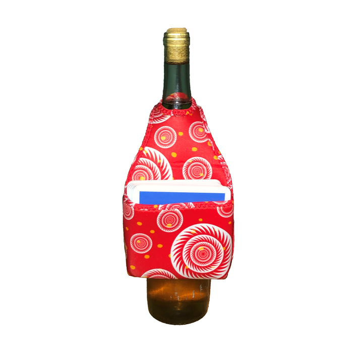 The HOOK-r by Drinks On Me is a wine bottle in a red, patterned neoprene pouch with circular designs and a front pocket holding a white and blue card, displayed on a white background.