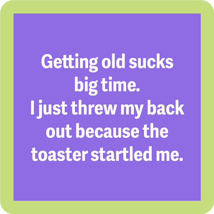 A purple square with a light green border reads: Getting old sucks big time. I just threw my back out because the toaster startled me. The Coaster Bundle: Birthday by Drinks On Me is a hilarious gift for friends who love to laugh.