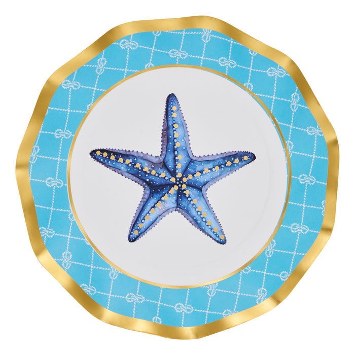 The Sophistiplate Tidal Wave Salad Plates (8pk) feature a wavy edge, blue and yellow starfish center, gold rim, and blue border with white knots—ideal coastal-themed tableware for ocean-inspired parties.