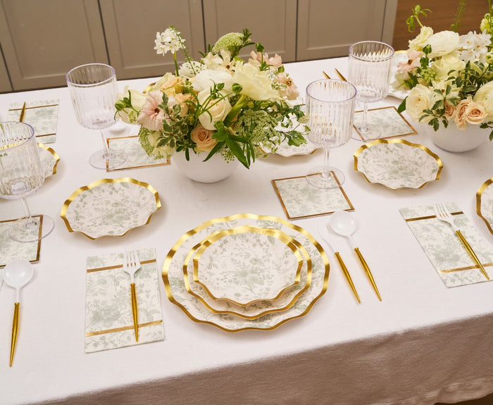 Elevate your table with Sophistiplate's Timeless Sage Appetizer/Dessert Bowls (8pk), paired with gold utensils, clear glasses, floral centerpieces in white vases, and matching napkins on a white tablecloth.