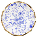 The Sophistiplate Timeless Salad Plates (8pk) feature a round white surface with a wavy gold rim, adorned with elegant blue floral and botanical designs—perfect disposable plates for special occasions.