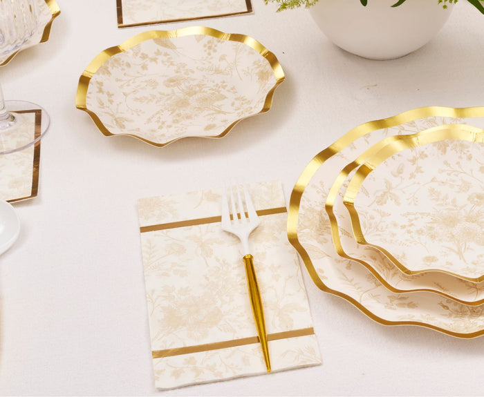 Create an elegant tablescape with Sophistiplate’s Timeless Table Setting: Sand, featuring scalloped ivory and gold plates, a matching fork and napkin, and floral dishware—perfect for effortlessly stylish occasions.