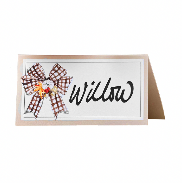 A folded Rosanne Beck Turkey & Gourds Bow Place Card with "Willow" in black cursive, featuring a brown and white checkered bow and small gourds—ideal for buffet labels or special events. Comes in a 10-pack.