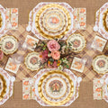 Sure! Here’s the revised sentence using your provided product data: Celebrate Thanksgiving in style with the Turkey & Gourds Table Setting by Sophistiplate, a fall-themed party-in-a-box that includes designer disposable plates adorned with turkeys and pumpkins, gold chargers, a floral centerpiece featuring pink roses, a plaid tablecloth, and matching napkins—all beautifully coordinated to create stunning Thanksgiving table decor when viewed from above.