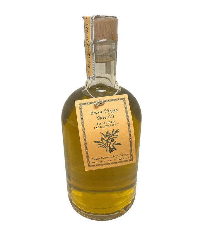 A glass bottle of Bella Cucina Taste of Tuscany Extra Virgin Olive Oil, featuring a golden label that reads "Extra Virgin Olive Oil, First Cold Stone-Pressed," and a sealed tag with product details.