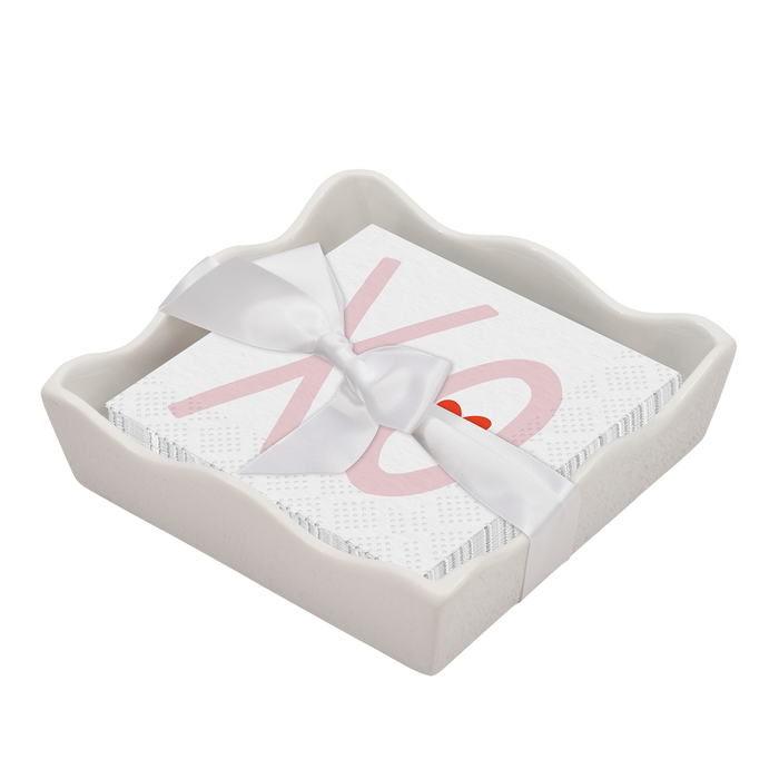 The Sophistiplate Valentines Day Cocktail Napkin with Napkin Tray features a white ceramic tray and napkins with a pink XO design and small red heart, tied with a white satin ribbon—an elegant touch for modern tables.