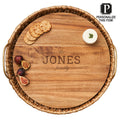 The Maple Water Hyacinth Round Tray with metal handles and acacia wood liner, personalized with the JONES family name, holds crackers, cheese, and figs. A label in the corner says: Personalize this item! Size: 17.5 x 17.5 x 4.5”.