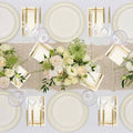 The Eco White & Gold Table Setting by Sophistiplate LLC features cream eco-friendly plates, gold cutlery, clear glasses, and decorative napkins on a lace runner with white and blush floral centerpieces for a formal table.