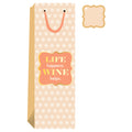 The Wine Helps- Wine Bag by Drinks On Me features a beige polka-dot design, pink handle, and “LIFE happens. WINE helps.” label. It’s ideal for hostess gifts and comes with a matching gift tag in the top right corner.