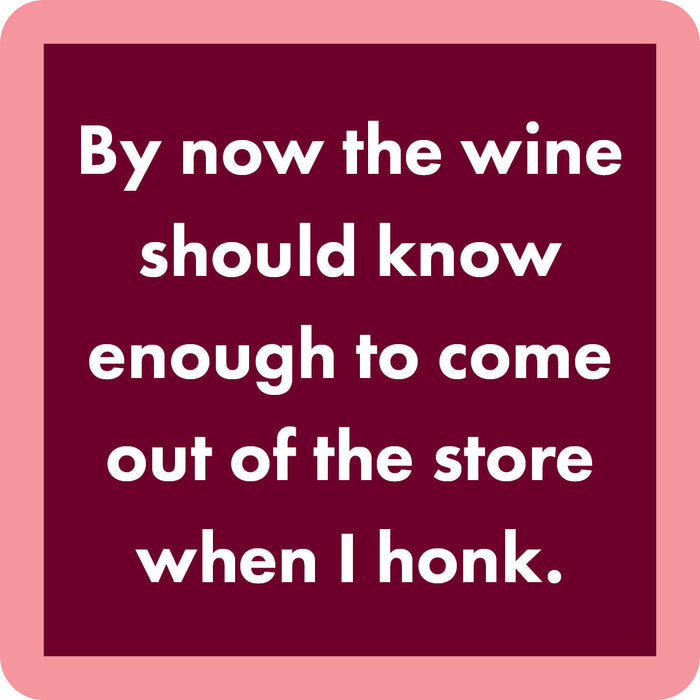 The Drinks On Me Wine Honk Coaster features white text on a maroon square with a light pink border—perfect as a funny housewarming gift or bar cart accessory.