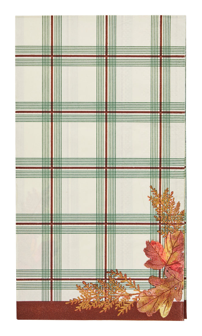 Sophistiplate Woodland Harvest Guest Towels (20pk) feature a white plaid design with green and brown stripes, accented by autumn leaves in vibrant red, yellow, and orange tones in the lower right corner—perfect for adding a festive touch to your Thanksgiving table or using as seasonal guest napkins.