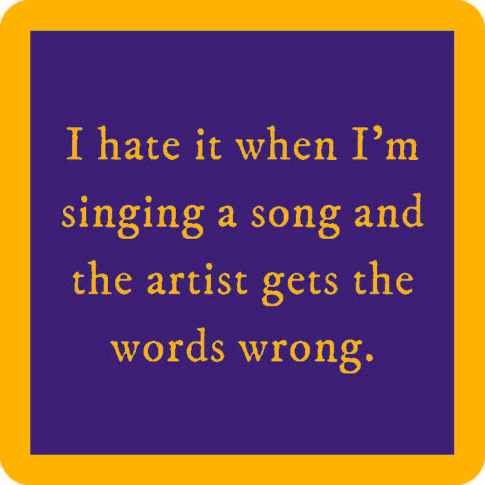 Yellow text on a blue background reads: I hate it when I’m singing a song and the artist gets the words wrong. The Drinks On Me Words Wrong Coaster, featuring a thick yellow border, makes a fun housewarming gift.