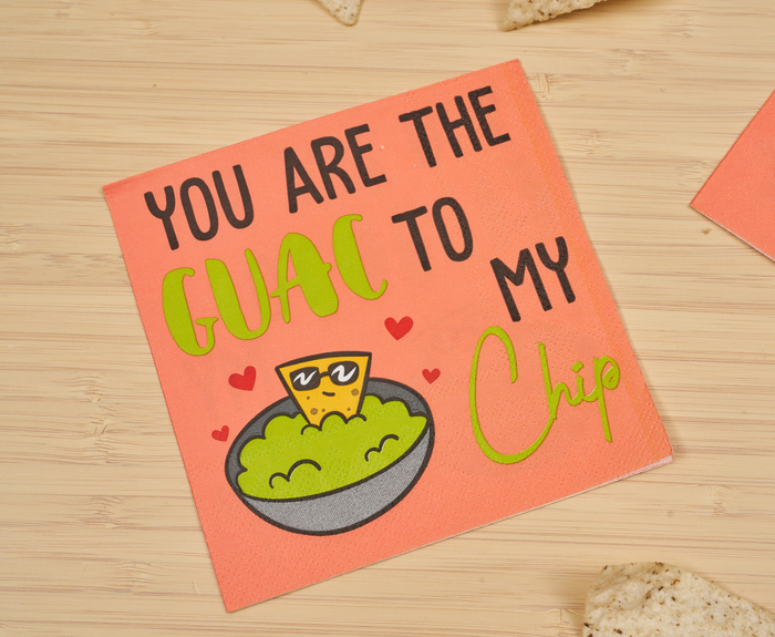 The Sugarplum "You are the GUAC to my Chip" Cocktail Napkins (26pk) feature playful fonts and a cartoon chip in sunglasses chilling in guac, with cheerful red hearts—perfect for your coral-toned beach party!.