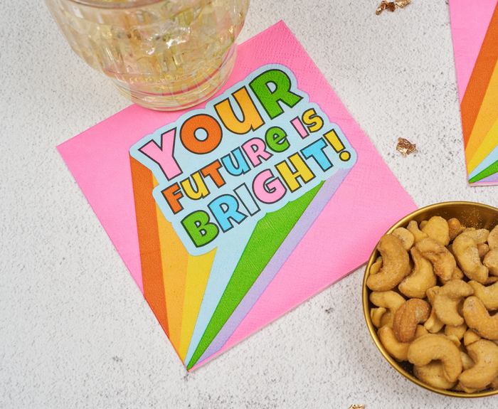 Sugarplum’s "Your future is bright" Cocktail Napkins (26pk) add cheerful color with pink and rainbow stripes—perfect for graduation parties.